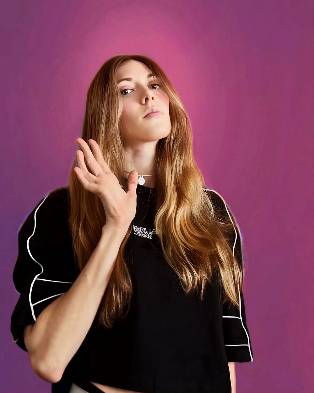 Portrait of HAYLEEN, singer, songwriter and producer, against a magenta background